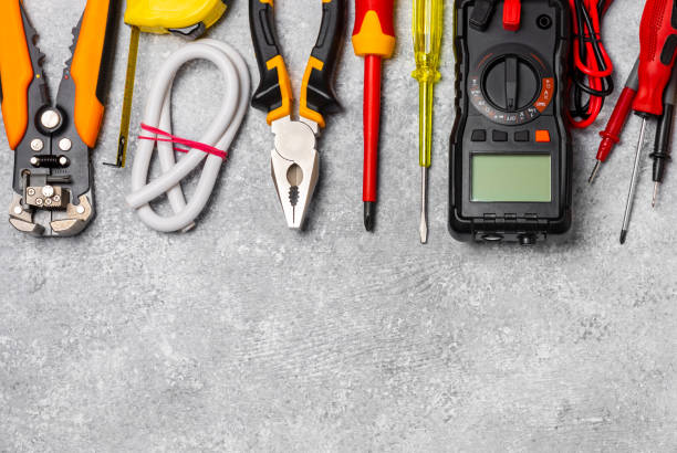 istock Electrician equipment on marble background with copy space.Top view.Electrician tool set.Multimeter, tester,screwdrivers,cutters,duct tape,lamps,tape measure and wires.Flet lay. 1737428042
