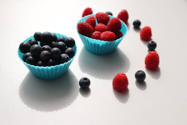istock white plate with raspberries and blueberries on a white background 1737432405