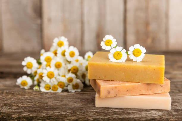 istock Chamomile spa. Composition with chamomile flowers, handmade soap, essential oil cosmetic bottle, body cream, scrub and sea salt on a white texture background. Relaxing beauty treatments.Copy space 1737435155