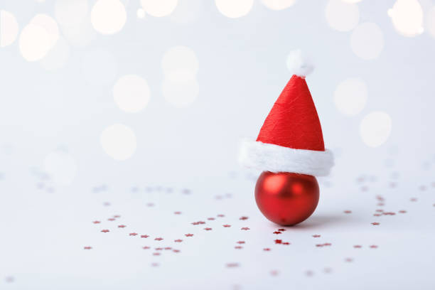 istock Christmas ball with Christmas hat on white background 1737435764