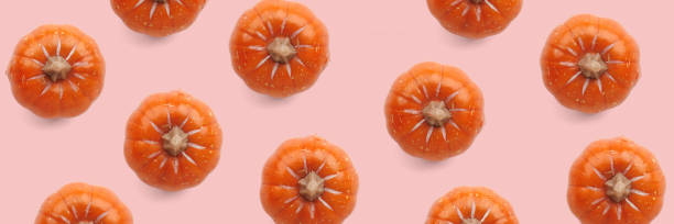 istock Orange pumpkin pattern on pastel color background 1737436327