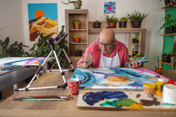 istock Senior Artist Demonstrating Watercolors 1737439108