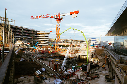 Delft, The Netherlands - April 25, 2019: Construction site with mobile crane and concrete stakes near Delft railway station