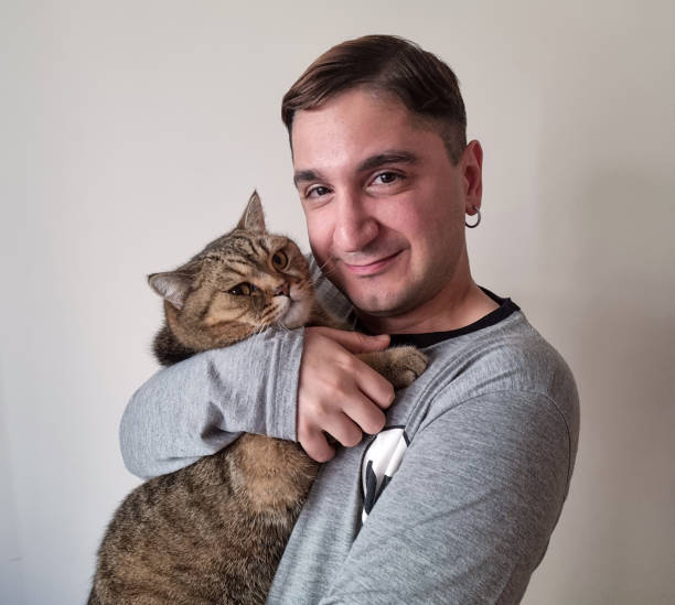 istock Cat and young man looking at camera with selfie 1737445020