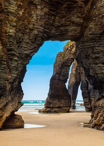 Natural rock arches Cathedrals beach, Playa de las Catedrales at Ribadeo, Galicia, Spain. Famous beach in Northern Spain Atlantic. Natural rock arch on Cathedrals beach in low tide