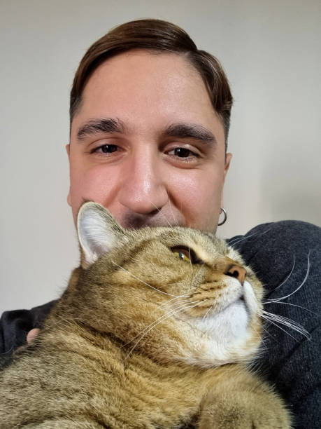 istock Cat and young man looking at camera with selfie 1737445576