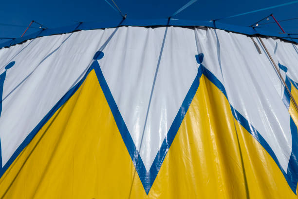 Circus tent blue, yellow and white pattern,, against the blue sky