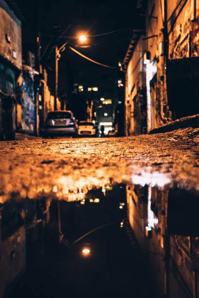 istock Dark alley reflected in puddle. Tel Aviv, Israel 1737452578