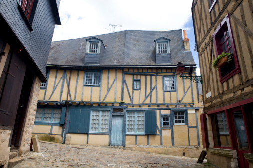 Frontal view of the facade of a traditional house with blue woodwork, Le Mans, France.