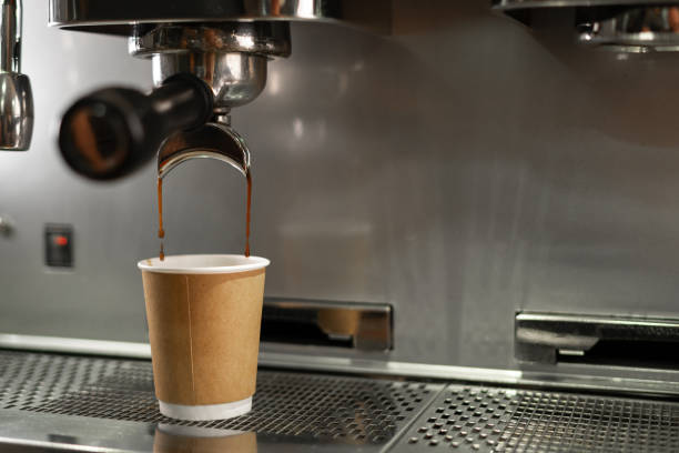 istock Coffee extraction in paper cup from professional coffee machine with portafilter 1737471700