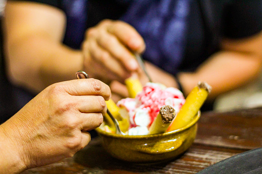Photo of two people eating  a bowl of ice cream