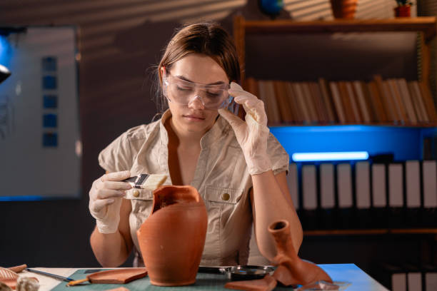 istock Beautiful female archeologist working late night in office. 1737472845