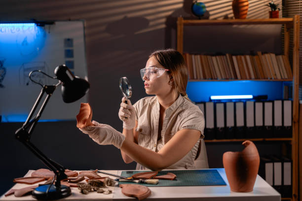 istock Archeologist working late night in office with ancient Slavic and Baltic ceramics from archeological excavations. 1737473362
