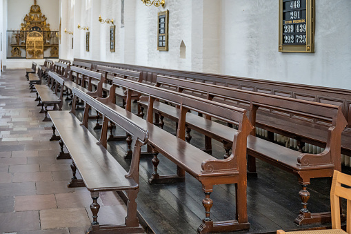 Empty old wooden benches at Aarhus Cathedral Church, Denmark