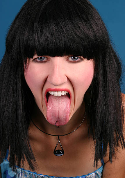 lato selvaggio - pierced human tongue tongue stud teenager foto e immagini stock