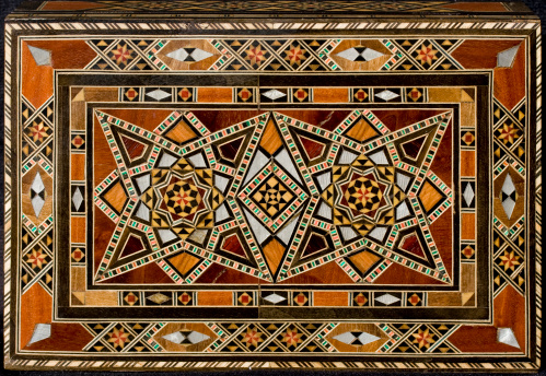 Traditional Arab design on the top of a wooden box.  These boxes and designs are found on many things in many places around the Arab world