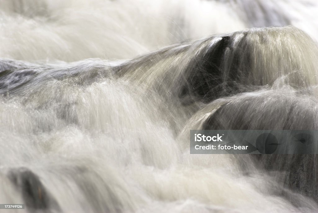 waterfall motion blurred image of a waterfall spilling over rocks Abundance Stock Photo