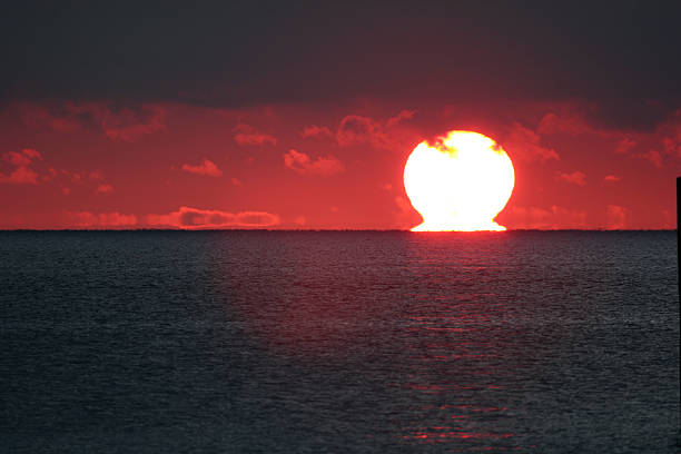 Fiery Red sunrise over the ocean stock photo