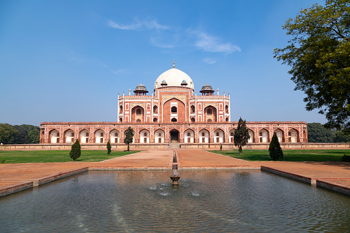 The Humayun's Tomb in Delhi stands as an architectural masterpiece and a pivotal example of Mughal design. Built in 1570, this tomb laid the groundwork for Mughal structures that followed, most notably the Taj Mahal. The complex features an amalgamation of Persian and Indian architectural elements, including the charbagh—a four-quadrant garden layout. This image captures the tomb's well-preserved facades, intricate stonework, and lush gardens, providing a comprehensive view of this UNESCO World Heritage site. The photograph aims to highlight both the historical and aesthetic elements that make this monument a must-visit landmark in India.