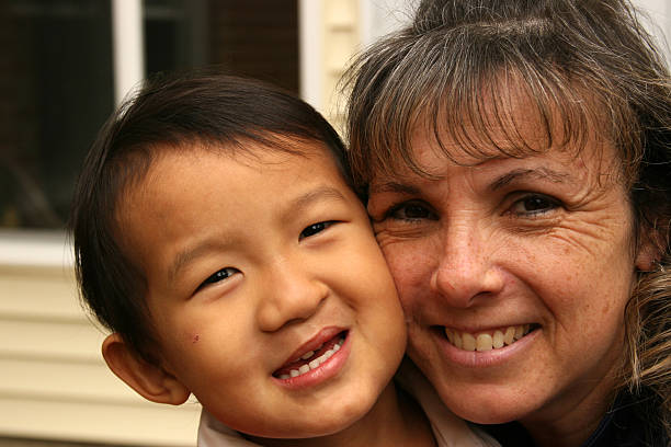 Smiling Son and Mother Chinese little boy cheek to cheek with his Mom cleft lip stock pictures, royalty-free photos & images