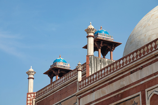 The Humayun's Tomb in Delhi stands as an architectural masterpiece and a pivotal example of Mughal design. Built in 1570, this tomb laid the groundwork for Mughal structures that followed, most notably the Taj Mahal. The complex features an amalgamation of Persian and Indian architectural elements, including the charbagh—a four-quadrant garden layout. This image captures the tomb's well-preserved facades, intricate stonework, and lush gardens, providing a comprehensive view of this UNESCO World Heritage site. The photograph aims to highlight both the historical and aesthetic elements that make this monument a must-visit landmark in India.