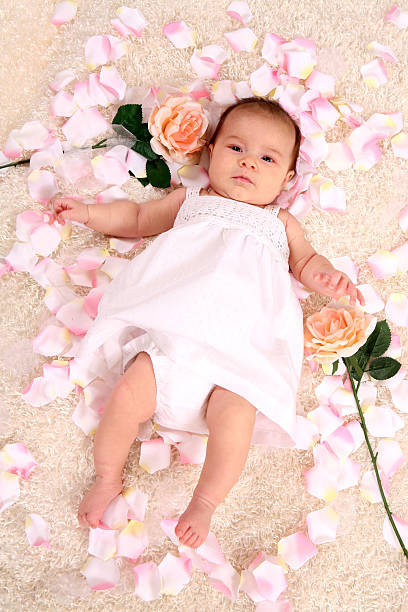 Baby surrounded by rose petals. Please view all pictures from this series along with other images of