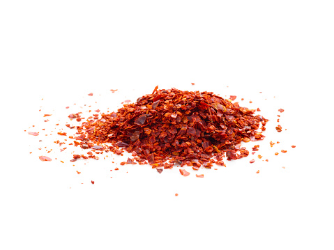 Crushed red pepper heap isolated on white background