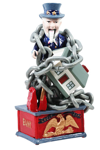 Uncle sam and house Uncle sam and enchained house. This is an old cast iron Uncle sam mechanical bank. uncle sam broke stock pictures, royalty-free photos & images