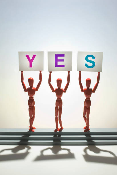 Figures holding yes sign stock photo