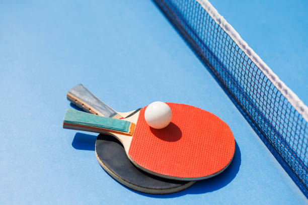 istock tennis rackets for playing ping pong on blue table, ping pong concept 1737521053