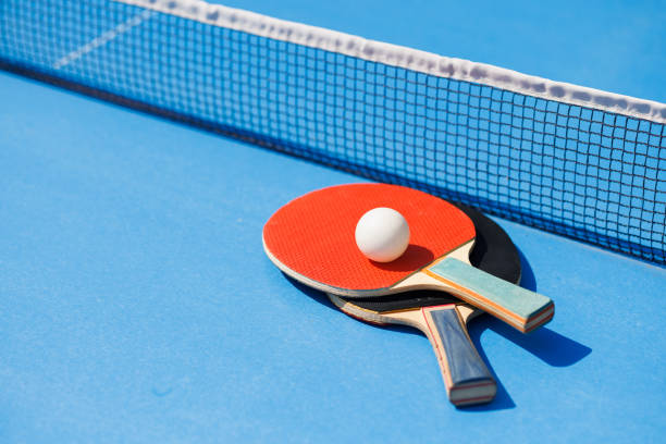 istock tennis rackets for playing ping pong on blue table, ping pong concept 1737521200