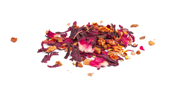 tea with candied fruit and rose petals on white background