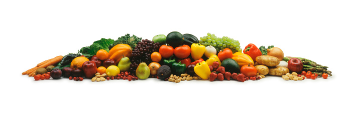 A variety of fruits and vegetables in a pile on a white background.  The pile is laid out in a very strong horizontal shape.