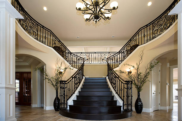 istock Grand Entryway with dual iron staircase interior architecture design 173753150
