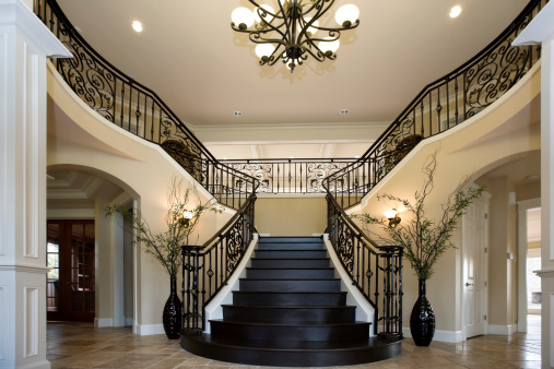 Grand Entryway with dual iron staircase interior architecture design