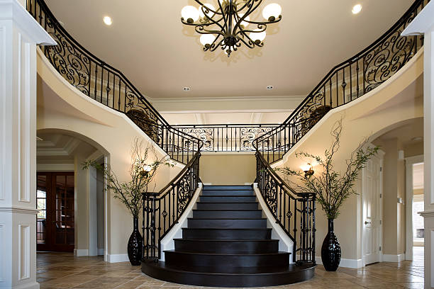 Grand Entryway with dual iron staircase interior architecture design Grand Entryway with dual iron staircase interior architecture design chandelier photos stock pictures, royalty-free photos & images