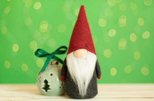 istock Christmas dwarf on table against blurred lights 1737537069