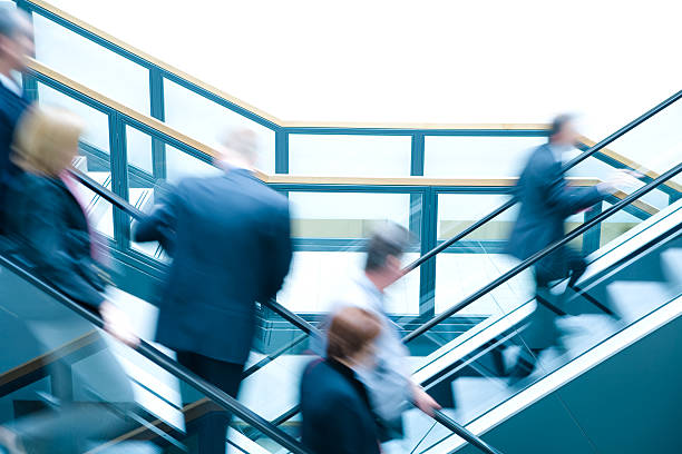 istock Business people on escalators, blurred motion 173753891