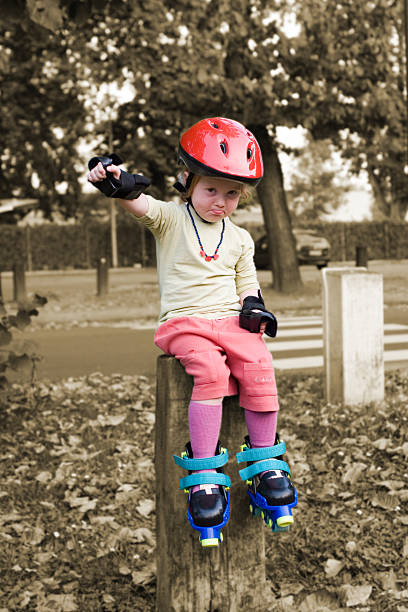 istock Little girl with helmet and rollerskates 173754023