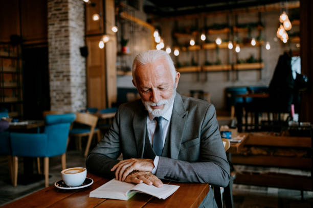 istock Elderly patron engrossed in reading 1737543209