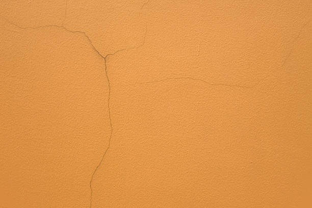 オレンジ色の壁の背景。 - orange wall textured paint ストックフォトと画像