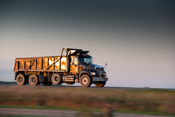 istock Dump truck speeds down the highway 173754996