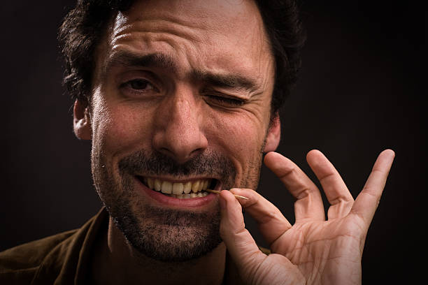 Man with toothpick in mouth Man with toothpick in mouth toothpick stock pictures, royalty-free photos & images