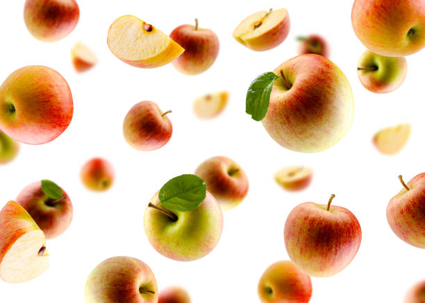 istock Excellently retouched multi colored apples with leaves whole halves and slices fly and levitate in space.  Surround light from behind. Isolated on white 1737553574