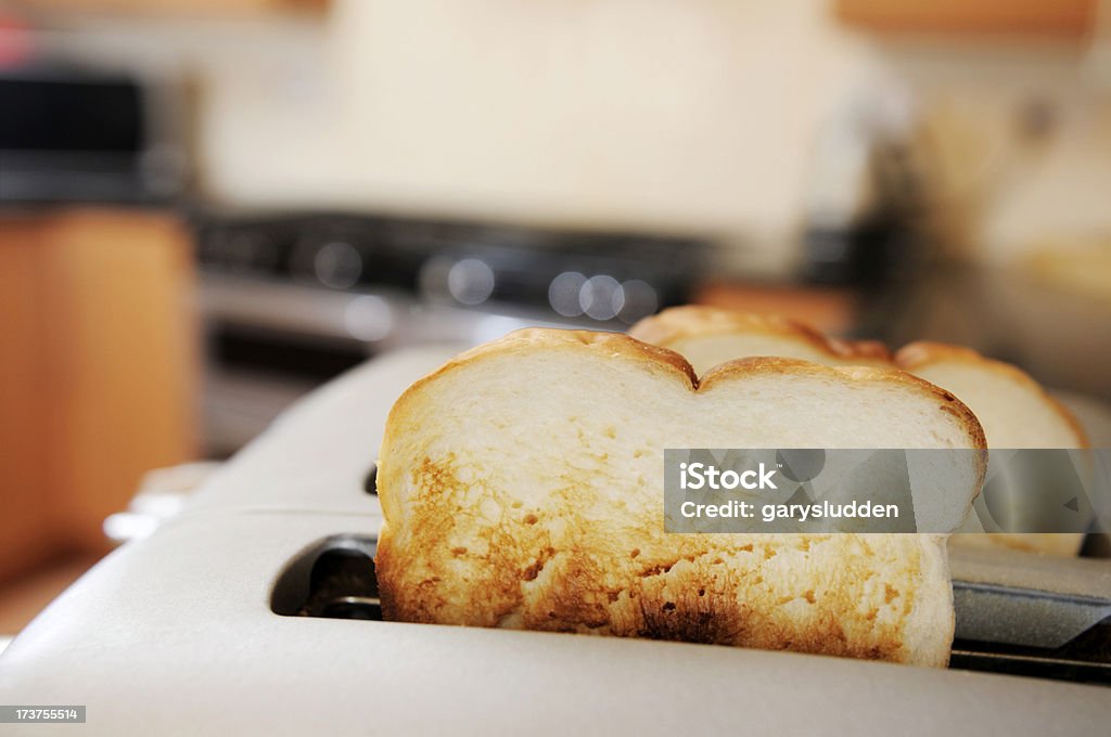 toast popping from toaster selective focus shot of toast popping up from toaster Beige Stock Photo