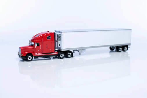 Miniature model of a red 18 wheeler truck and trailor