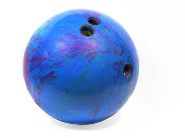 Purple and blue bowling ball with three drilled holes stock photo