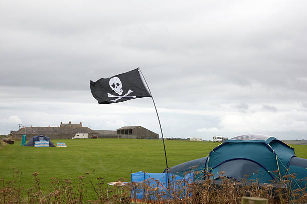 istock Jolly Roger flag at campsite 173756532