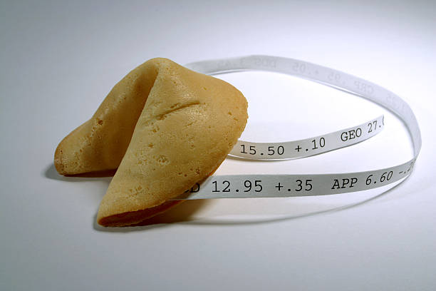Fortune Cookie: Stocks Fortune cookie with (fictious) stock numbers on it. ticker tape machine stock pictures, royalty-free photos & images