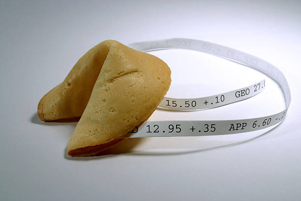 Fortune Cookie: Stocks Fortune cookie with (fictious) stock numbers on it. fortune telling machine stock pictures, royalty-free photos & images